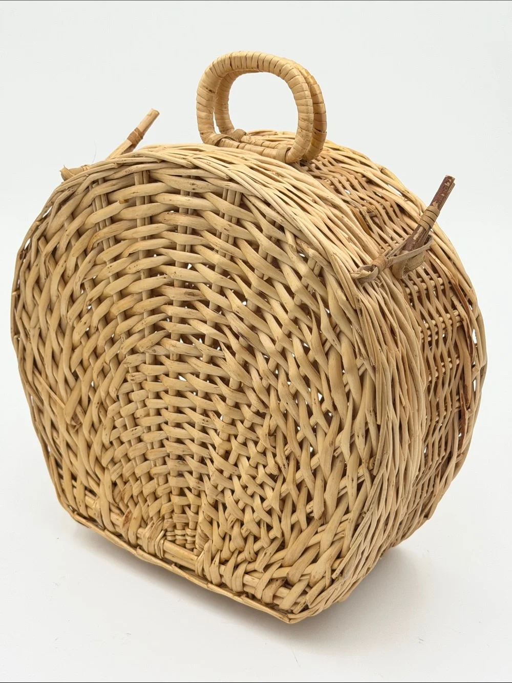 A Cute, charming vintage shell-shaped rattan storage basket with a front handle.